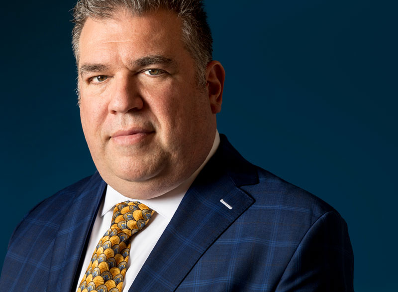 headshot of Scott the Magician on a dark blue background