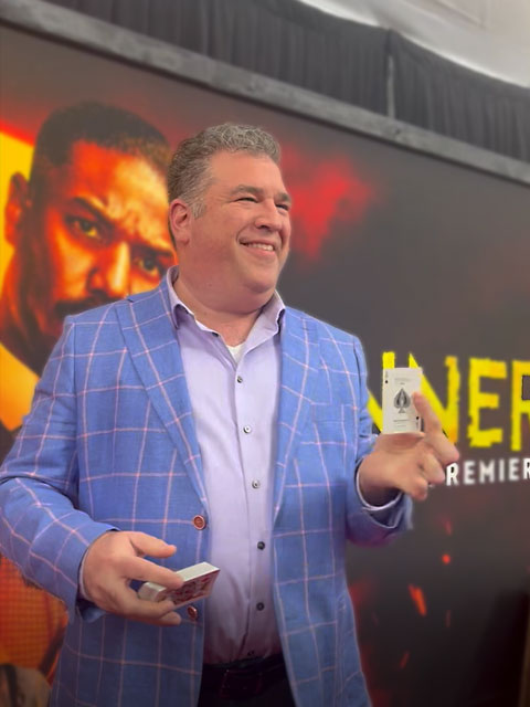 Scott performing card magic at a movie premiere.